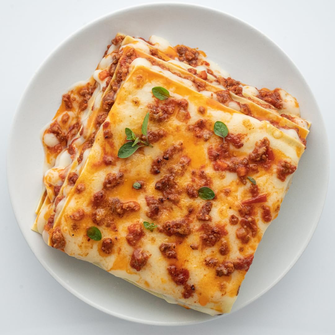 A freshly baked lasagna made from the My Cooking Box Lasagna Kit, golden brown and bubbling with cheese.